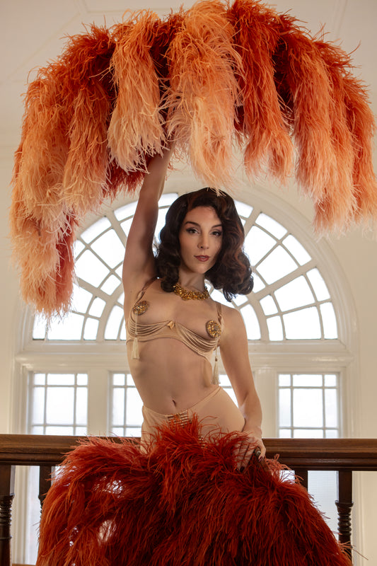 Nude beige satin quarter cup bra with vintage 1950s bullet bra inspired spiral stitching. Worn by a burlesque dancer, ideal showgirl lingerie costume. Bespoke lingerie made to measure in the UK