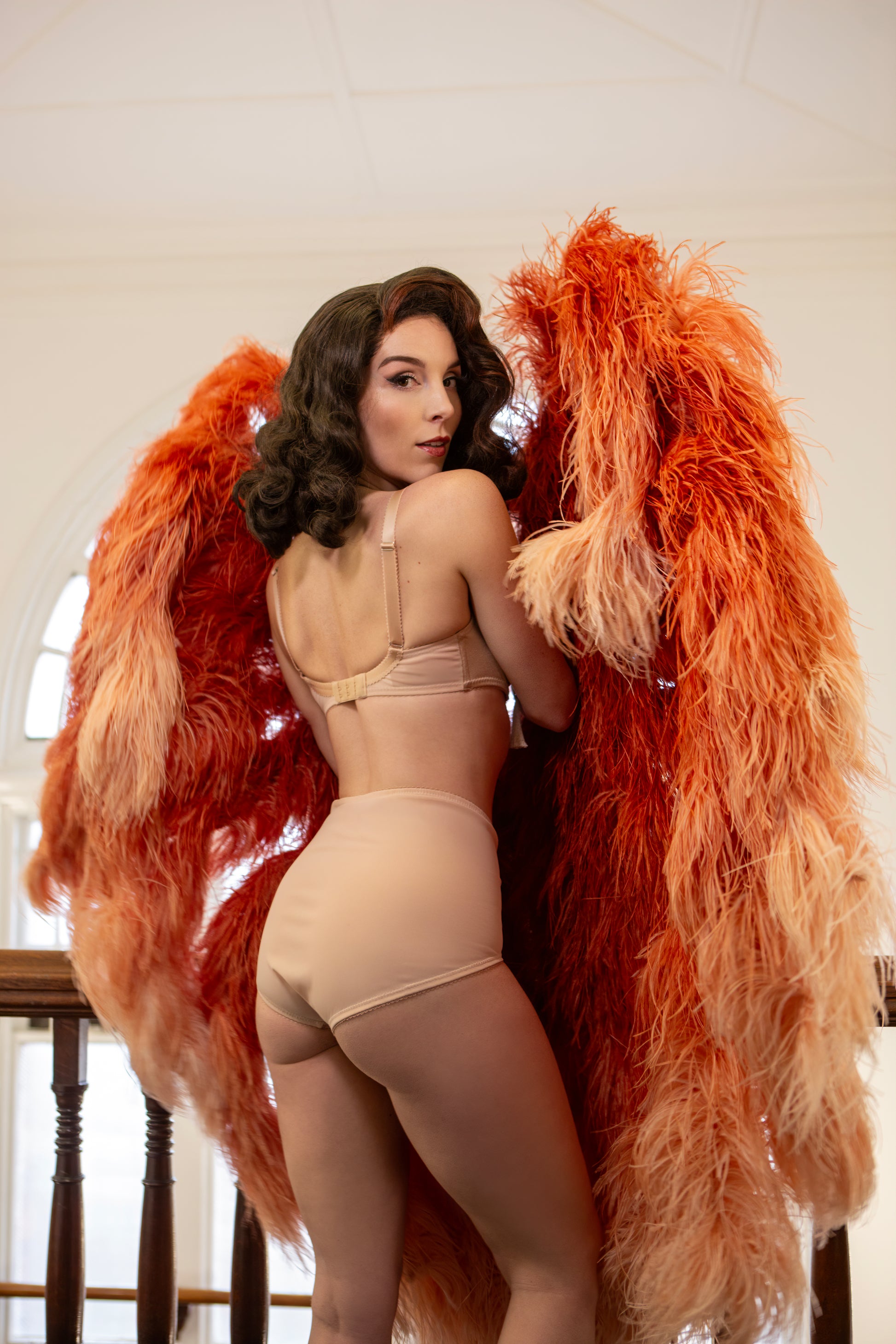 Nude beige satin high waisted knicker pantie with vintage 1950s bullet bra inspired spiral stitching. Worn by a burlesque dancer, ideal showgirl lingerie costume. Bespoke lingerie made to measure in the UK