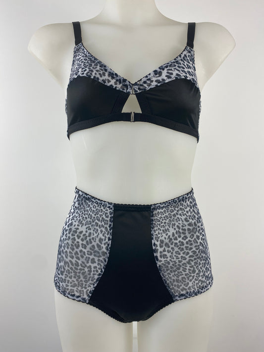 Side view of the Pip & Pantalaimon Monochrome High Waisted Knicker, featuring a black satin front and sheer leopard mesh back for a flattering, vintage-inspired fit.