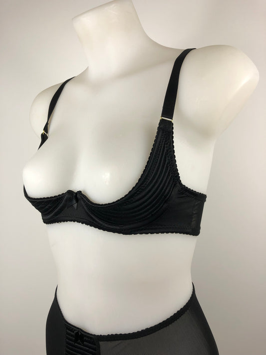 black satin quarter cup bra with vintage bullet bra inspired spiral stitching. Worn by a burlesque dancer, ideal showgirl lingerie costume. Bespoke lingerie made to measure in the UK