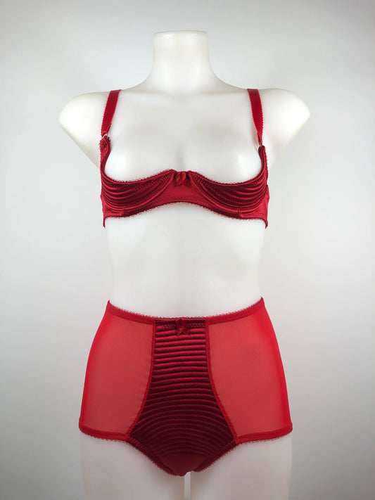 Red satin quarter cup bra with vintage bullet bra inspired spiral stitching. Worn by a burlesque dancer, ideal showgirl lingerie costume. Bespoke lingerie made to measure in the UK
