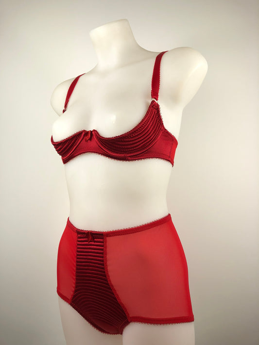 A red satin spiral-stitched underwired bra with a Performer Cut quarter cup style on a mannequin.