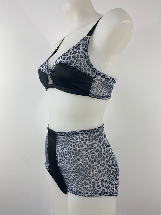 Side view of the Pip & Pantalaimon Monochrome High Waisted Knicker, featuring a black satin front and sheer leopard mesh back for a flattering, vintage-inspired fit.
