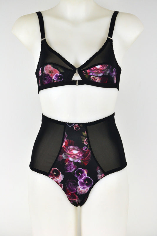 Black lingerie high waisted thong with floral design on a mannequin against a white background