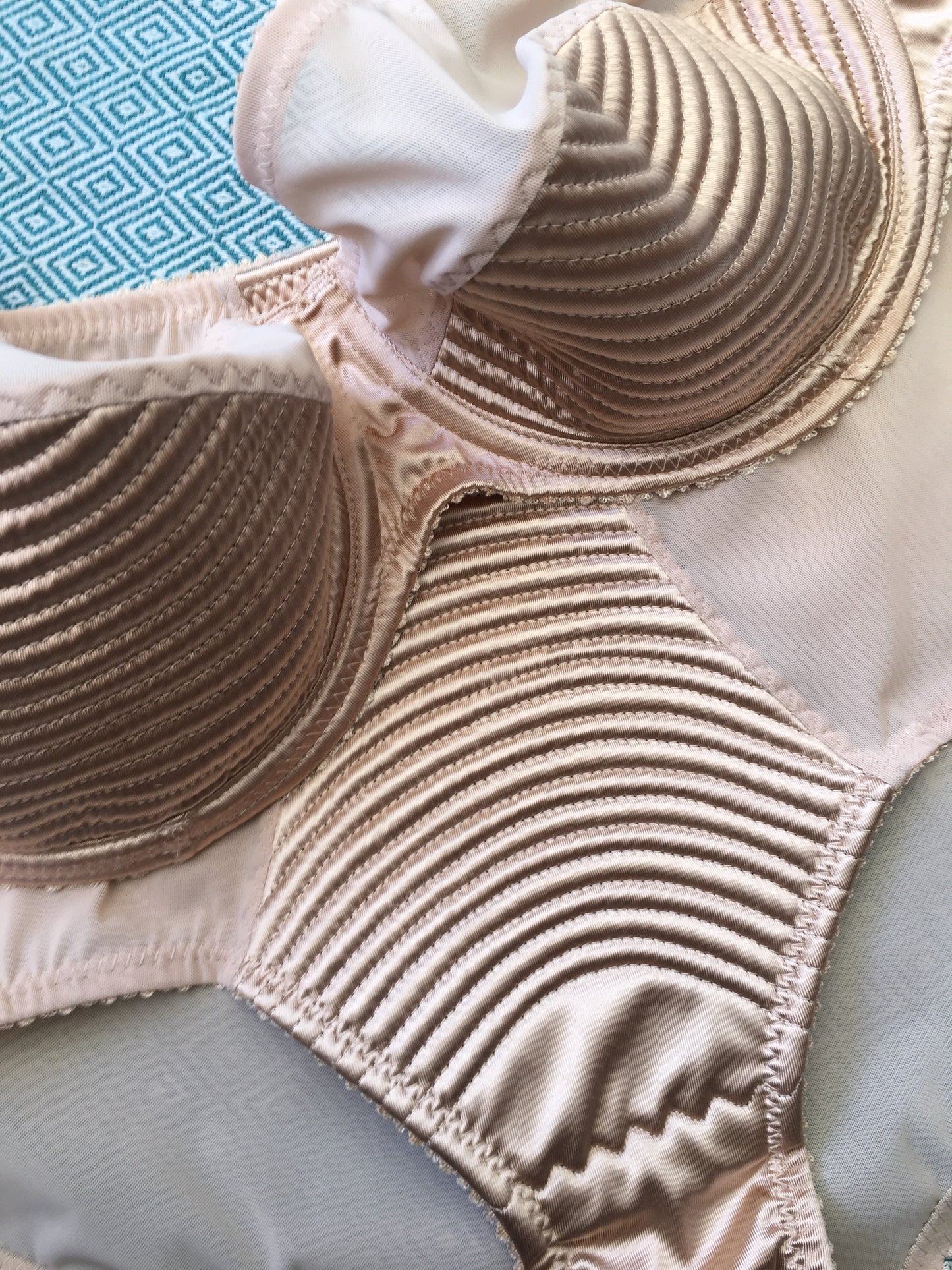 1950s bullet bra inspired underwire bra in vintage peach biscotti satin. Padded spiral stitching circle stitch in 1940's lingerie style.