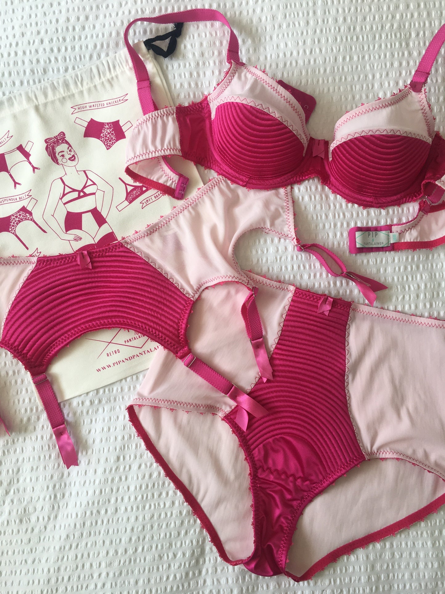 hot pink padded underwired bra with pale pink mesh and vintage style spiral stitching on the lower cup. Inspired by vintage 1950s bullet bras but with a softer modern shape. Matching 6 strap suspender belt with metal garter clips and high waisted pantie girdle knicker also available. Barbie vibe lingerie and underwear to be worn with seamed stockings