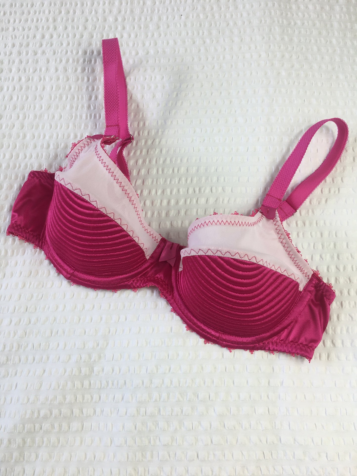 hot pink padded underwired bra with pale pink mesh and vintage style spiral stitching on the lower cup. Inspired by vintage 1950s bullet bras but with a softer modern shape. Matching 6 strap suspender belt with metal garter clips and high waisted pantie girdle knicker also available. Barbie vibe lingerie and underwear to be worn with seamed stockings