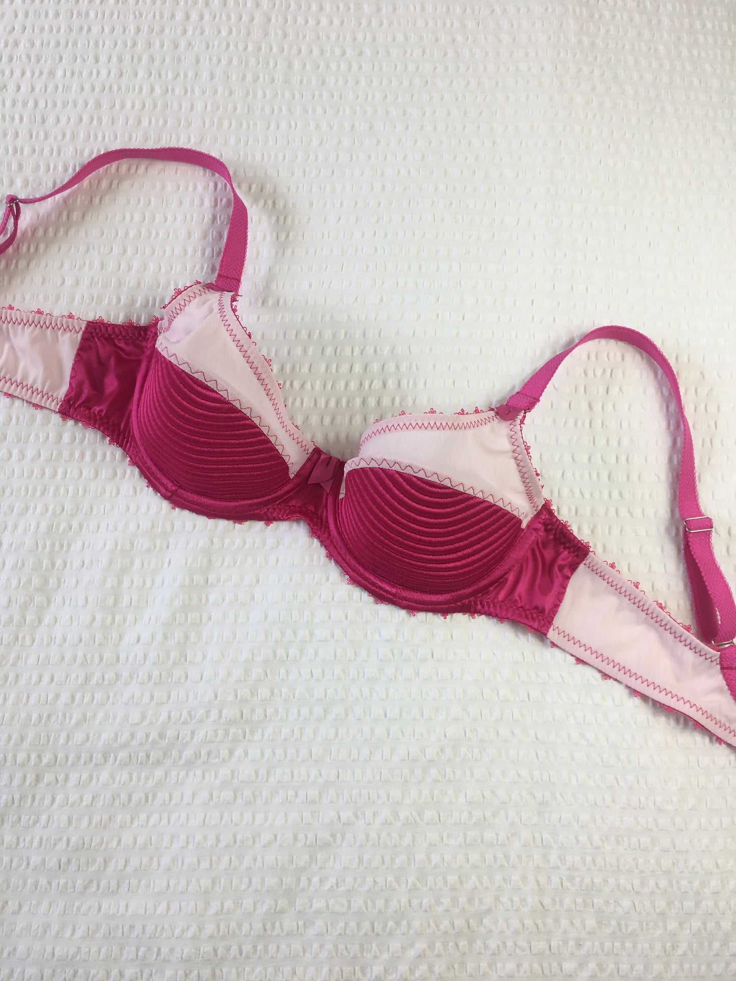 hot pink padded underwired bra with pale pink mesh and vintage style spiral stitching on the lower cup. Inspired by vintage 1950s bullet bras but with a softer modern shape. Matching 6 strap suspender belt with metal garter clips and high waisted pantie girdle knicker also available. Barbie vibe lingerie and underwear to be worn with seamed stockings