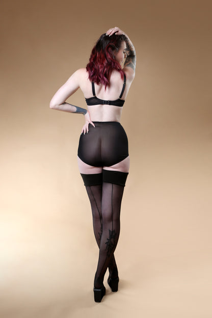 Red satin quarter cup bra with vintage bullet bra inspired spiral stitching. Worn by a burlesque dancer, ideal showgirl lingerie costume. Bespoke lingerie made to measure in the UK 