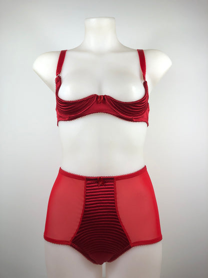 Red satin quarter cup bra with vintage bullet bra inspired spiral stitching. Worn by a burlesque dancer, ideal showgirl lingerie costume. Bespoke lingerie made to measure in the UK 