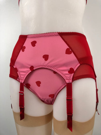 red and pink heart lingerie. vintage inspired six strap suspender belt with pink heart front and red mesh sides, perfect for valentines cheesecake pin ups, six suspender garter straps to hold up seamed stockings. A fun, bold, playful retro inspired underwear set