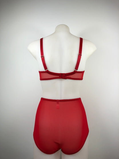 Red satin quarter cup bra with vintage bullet bra inspired spiral stitching. Worn by a burlesque dancer, ideal showgirl lingerie costume. Bespoke lingerie made to measure in the UK 