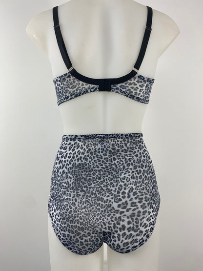 Front view of the Pip & Pantalaimon Monochrome Bralette with black satin lower cups and leopard mesh top cups and wings, featuring a vintage shape and front hook closure.