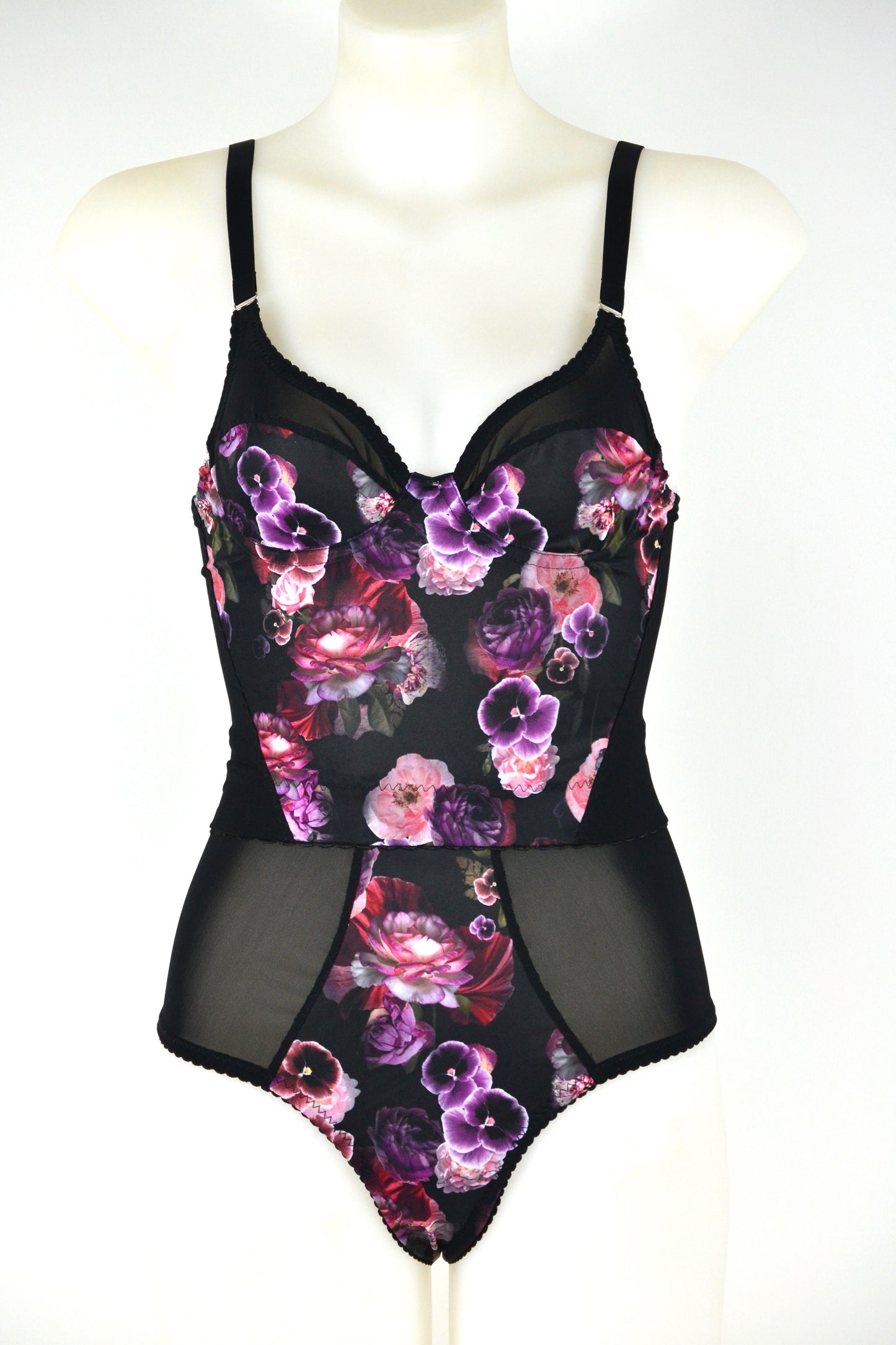 Black floral longline bra on a mannequin against a white background. vintage 1950s inspired underwear