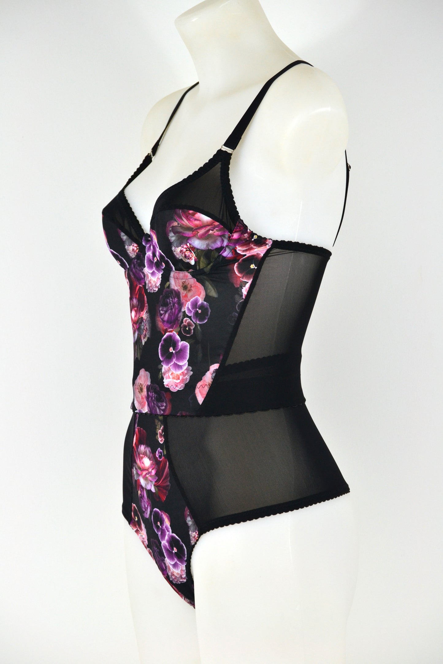 Black floral longline bra on a mannequin against a white background. vintage 1950s inspired underwear
