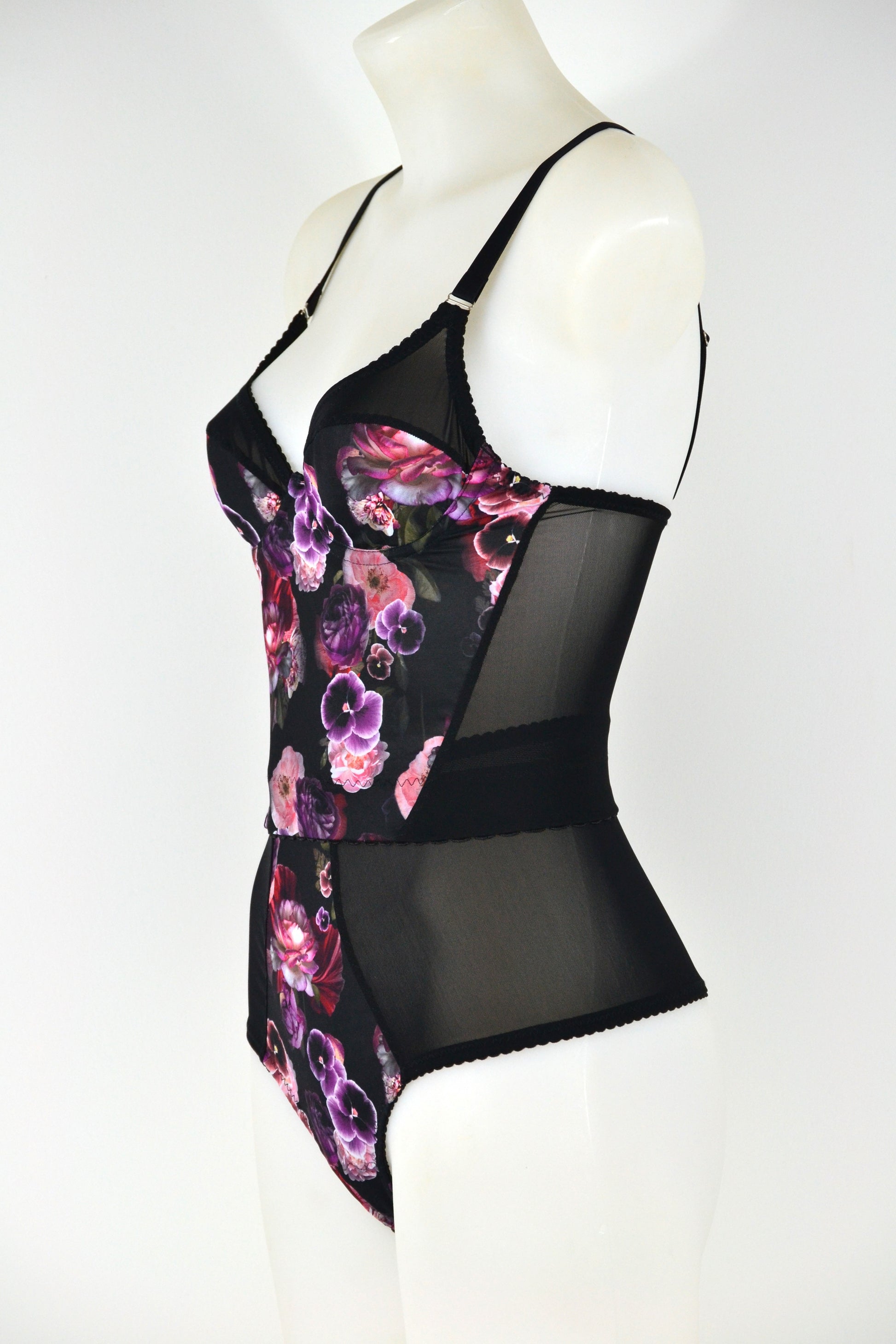 Black floral longline bra on a mannequin against a white background. vintage 1950s inspired underwear