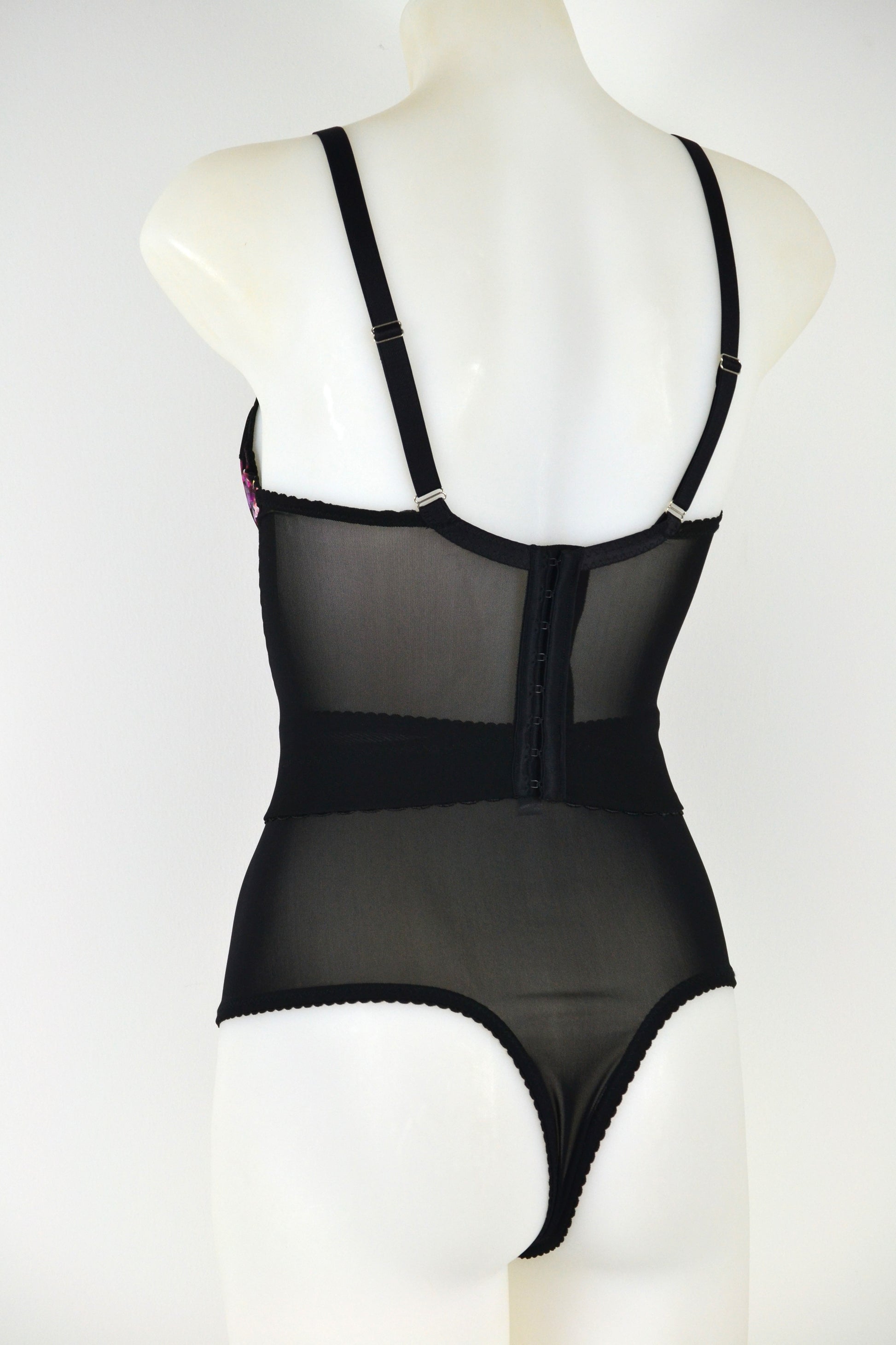 Black floral longline bra on a mannequin against a white background. vintage 1950s inspired underwear