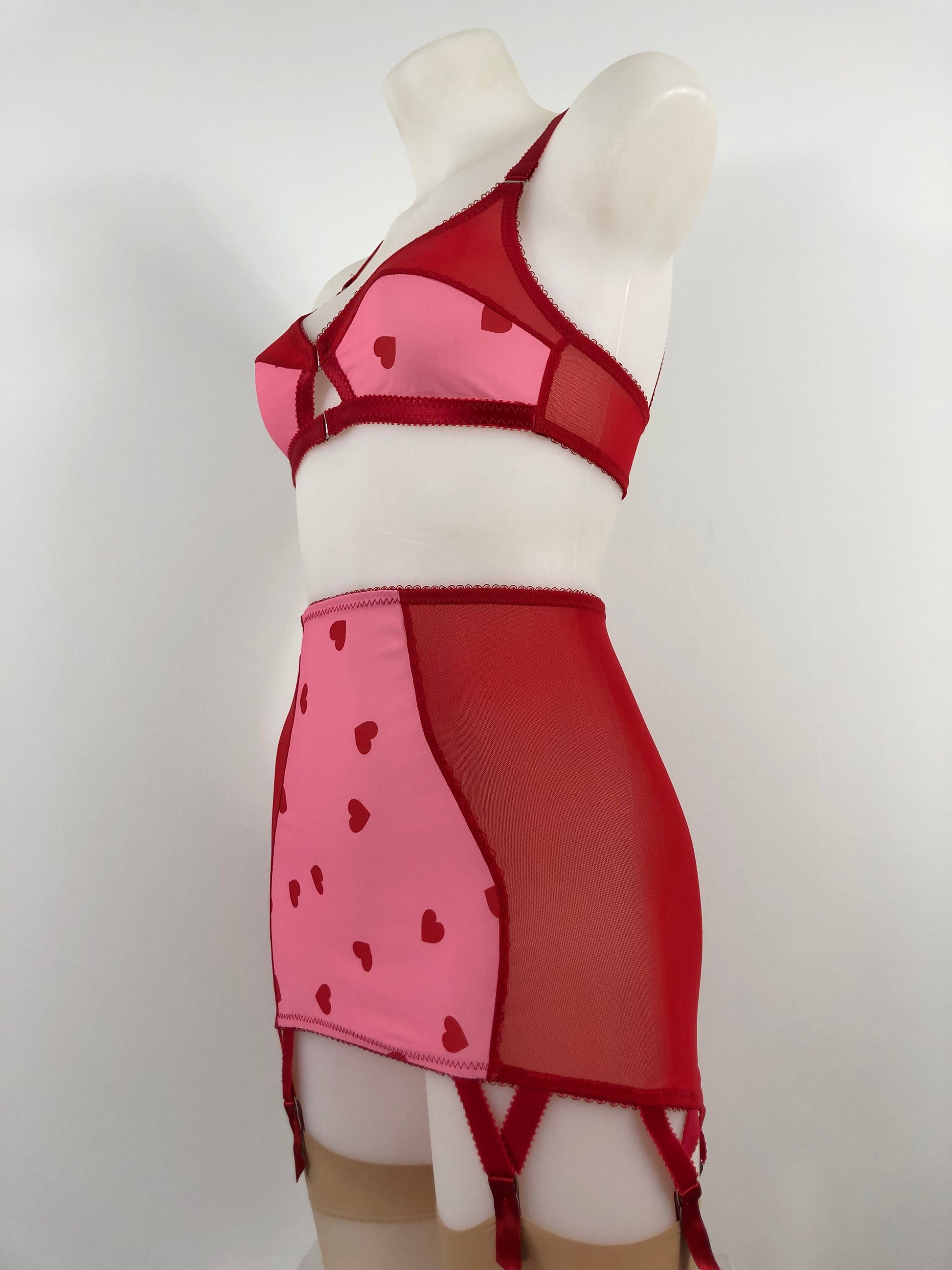 red and pink heart lingerie. vintage inspired longline girdle with pink heart front and red mesh sides, perfect for valentines cheesecake pin ups, six suspender garter clips to hold up seamed stockings. A fun, bold, playful retro inspired underwear set
