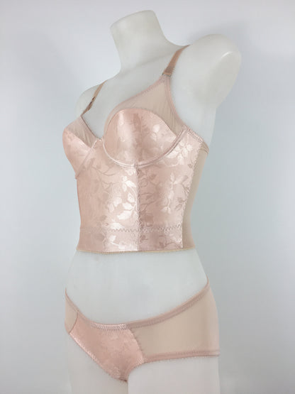 Our most authentic looking vintage inspired lingerie yet. Perfect peachy satin longline 1950s underwired bra. Peachy vintage front panels and nude biscotti mesh back. More subtle silhouette then a bullet bra, longline length makes this faux vintage bra perfect for wearing under true vintage dresses and fashion. Faux vintage reproduction lingerie made in the uk in a 1940s and 1950s underwear style