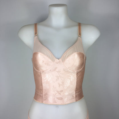 Our most authentic looking vintage inspired lingerie yet. Perfect peachy satin longline 1950s underwired bra. Peachy vintage front panels and nude biscotti mesh back. More subtle silhouette then a bullet bra, longline length makes this faux vintage bra perfect for wearing under true vintage dresses and fashion. Faux vintage reproduction lingerie made in the uk in a 1940s and 1950s underwear style