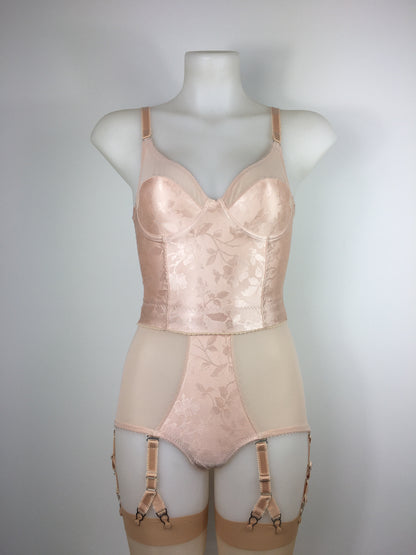 Our most authentic looking vintage inspired lingerie yet. Perfect peachy satin longline 1950s underwired bra. Peachy vintage front panels and nude biscotti mesh back. More subtle silhouette then a bullet bra, longline length makes this faux vintage bra perfect for wearing under true vintage dresses and fashion. Faux vintage reproduction lingerie made in the uk in a 1940s and 1950s underwear style