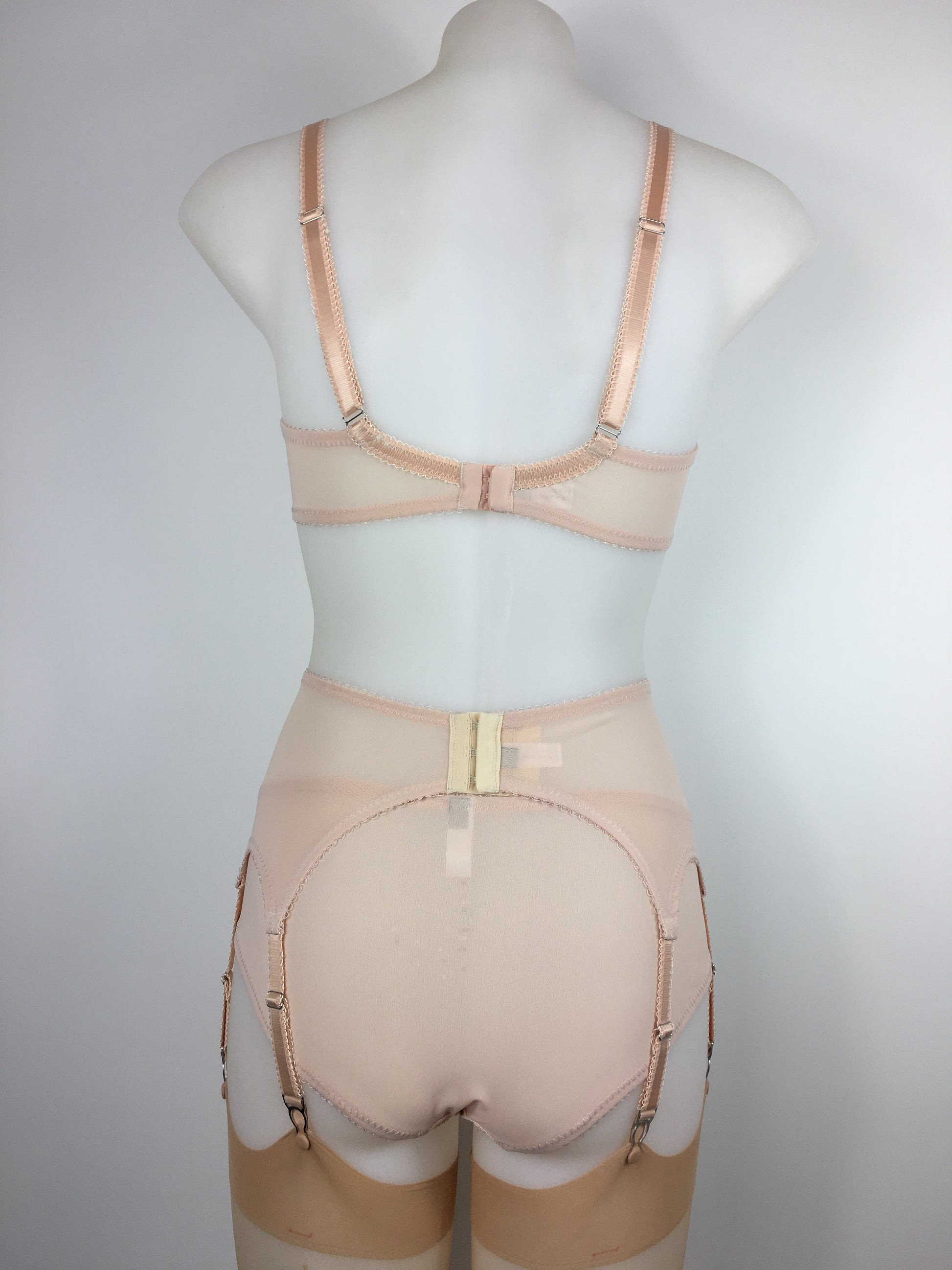 Our most authentic looking vintage inspired lingerie yet. Perfect peachy satin six strap suspender belt with a vintage peachy front panel and nude biscotti mesh sides. 6 adjustable suspender straps with a garter grip on each, perfect for holding your seamed stockings in place all day and for pairing with true vintage lingerie from 1920s, 1930s, 1940s and 1950s. Faux vintage lingerie