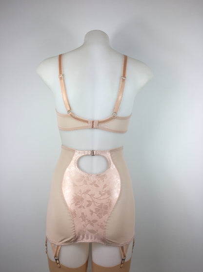 Our most authentic looking vintage inspired lingerie yet. Perfect peachy satin longline girdle with satin front and back panels. Keyhole back fastens with a steel hook after you've wiggled in. Perfect teamed with our faux vintage 1950s longline bra. The longline girdle has 6 metal suspender garter straps to keep your seamed stockings in place. Reproduction nude vintage lingerie made in the uk