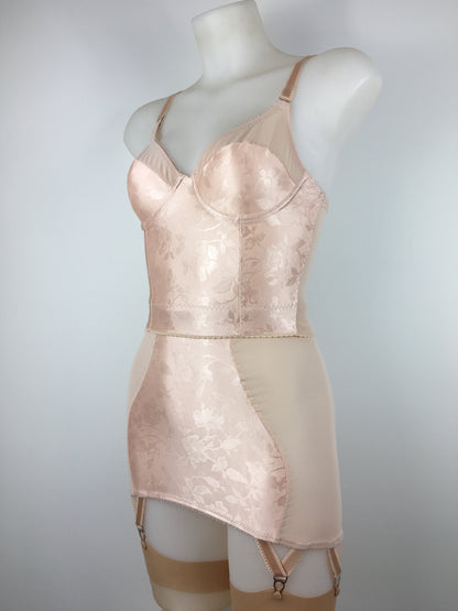 Our most authentic looking vintage inspired lingerie yet. Perfect peachy satin longline 1950s underwired bra. Peachy vintage front panels and nude biscotti mesh back. More subtle silhouette then a bullet bra, longline length makes this faux vintage bra perfect for wearing under true vintage dresses and fashion. Faux vintage reproduction lingerie made in the uk in a 1940s and 1950s underwear style