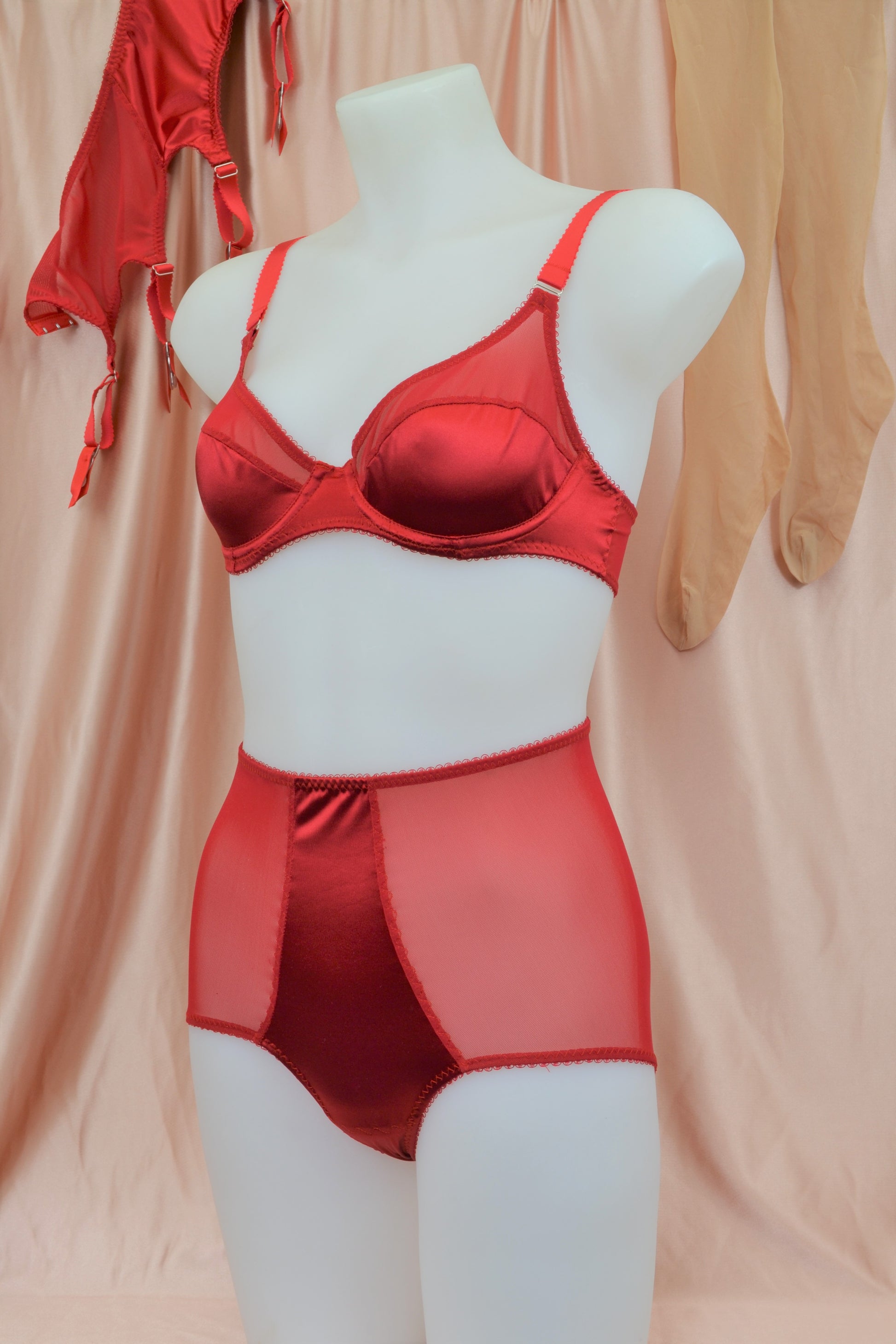 red satin shapewear lingerie. Vintage inspired valentines underwear. Red shapewear satin and red power net underwired bra, six strap suspender belt with steel garter clips and classic cut knicker or high waisted pantie girdle. Custom made red lingerie made to order in the UK. Red satin underwear with no lace. Perfect for Christmas and Valentines