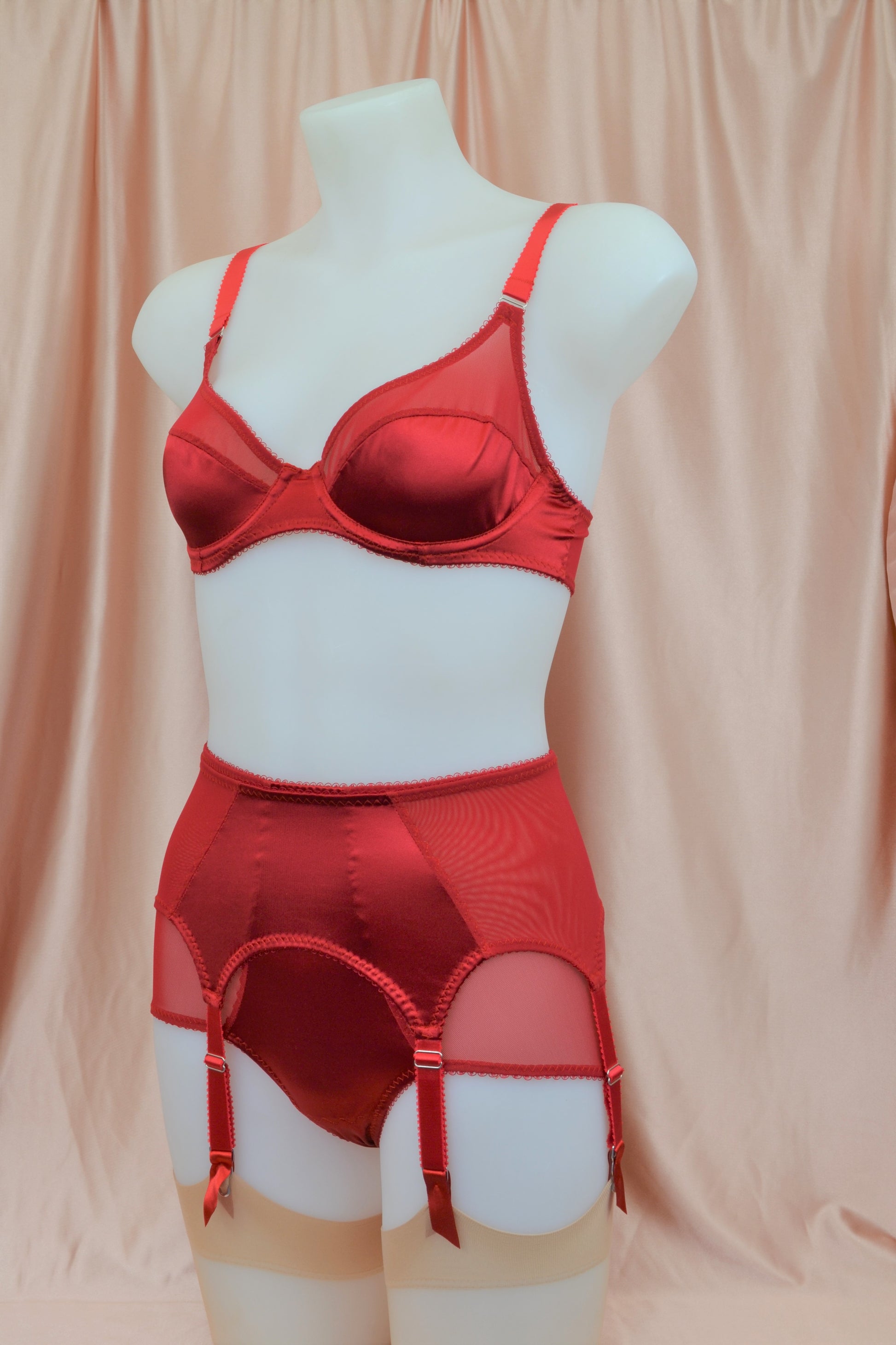 red satin shapewear lingerie. Vintage inspired valentines underwear. Red shapewear satin and red power net underwired bra, six strap suspender belt with steel garter clips and classic cut knicker or high waisted pantie girdle. Custom made red lingerie made to order in the UK. Red satin underwear with no lace. Perfect for Christmas and Valentines