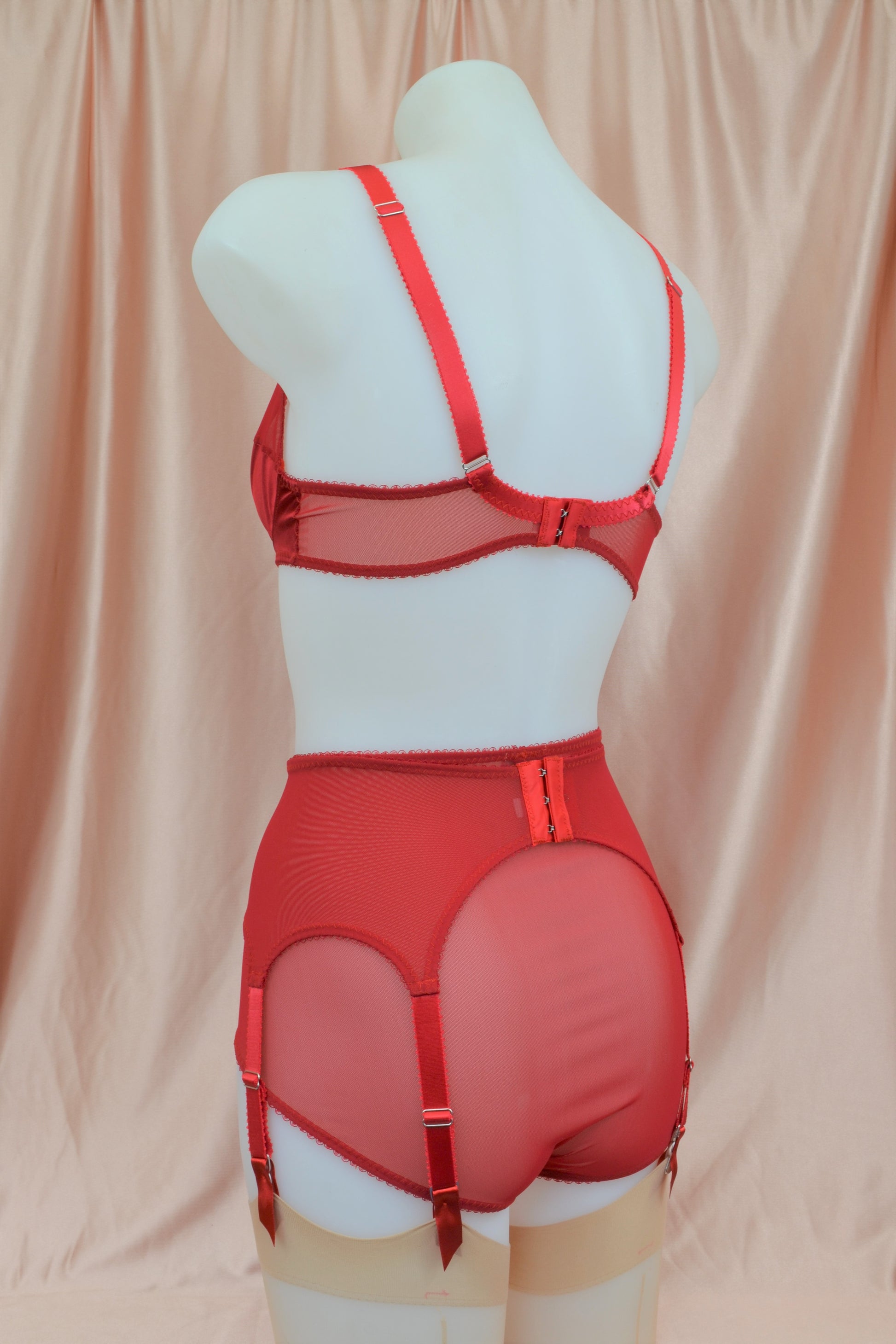 red satin shapewear lingerie. Vintage inspired valentines underwear. Red shapewear satin and red power net underwired bra, six strap suspender belt with steel garter clips and classic cut knicker or high waisted pantie girdle. Custom made red lingerie made to order in the UK. Red satin underwear with no lace. Perfect for Christmas and Valentines