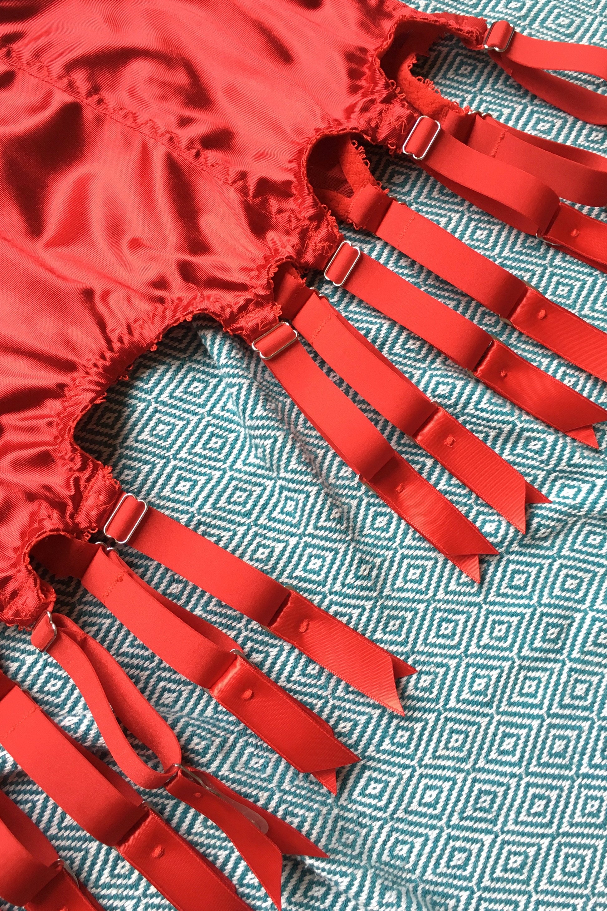 red satin shapewear lingerie. Vintage inspired valentines underwear. Red shapewear satin and red power net underwired bra, six strap suspender belt with steel garter clips and classic cut knicker or high waisted pantie girdle. Custom made red lingerie made to order in the UK. Red satin underwear with no lace. Perfect for Christmas and Valentines
