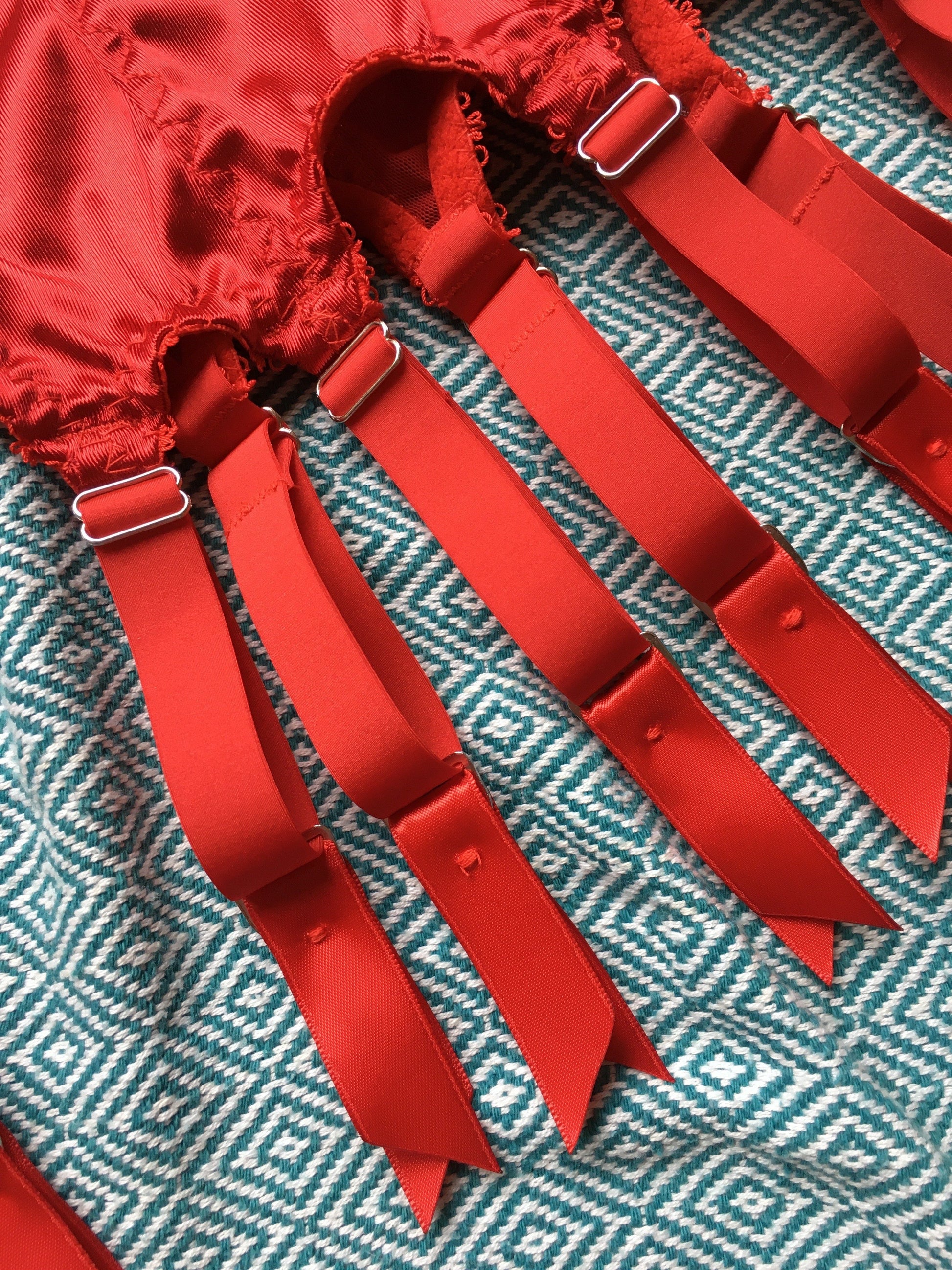red satin shapewear lingerie. Vintage inspired valentines underwear. Red shapewear satin and red power net underwired bra, six strap suspender belt with steel garter clips and classic cut knicker or high waisted pantie girdle. Custom made red lingerie made to order in the UK. Red satin underwear with no lace. Perfect for Christmas and Valentines