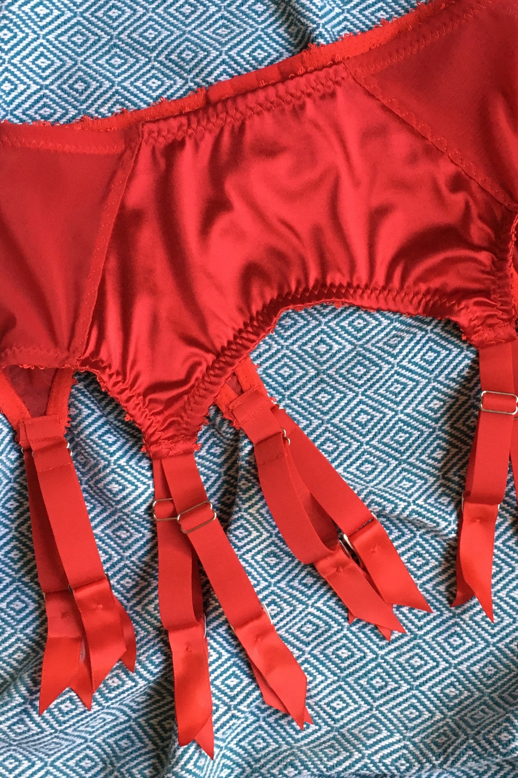 red satin shapewear lingerie. Vintage inspired valentines underwear. Red shapewear satin and red power net underwired bra, six strap suspender belt with steel garter clips and classic cut knicker or high waisted pantie girdle. Custom made red lingerie made to order in the UK. Red satin underwear with no lace. Perfect for Christmas and Valentines