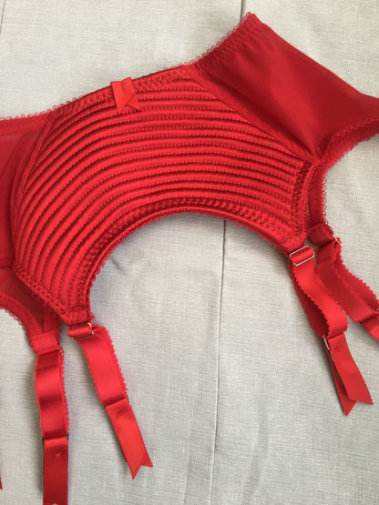 Spiral stitch lingerie 1950s bullet bra inspired underwear. reproduction foundations. Burlesque showgirl costume outfit spiral circle stitch six strap suspender belt, garter belt, underwired bra high waisted and classic cut panties knickers custom made in the UK in fabulous bright red satin. 