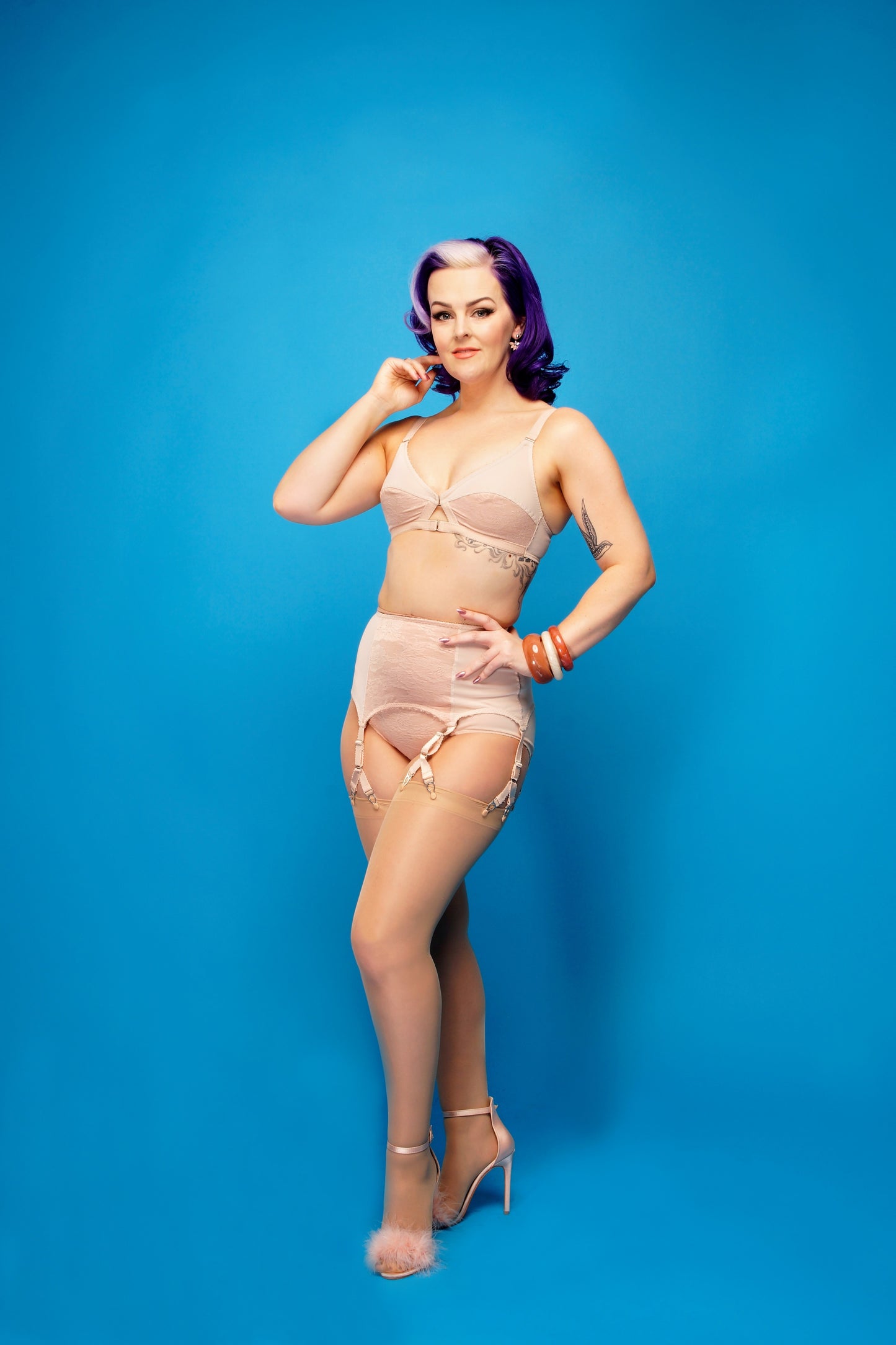seamed nylon stockings in a vintage style. Biscotti nude stockings with a pale nude welt and pale nude seam down the back. To be worn with suspender and garter belts