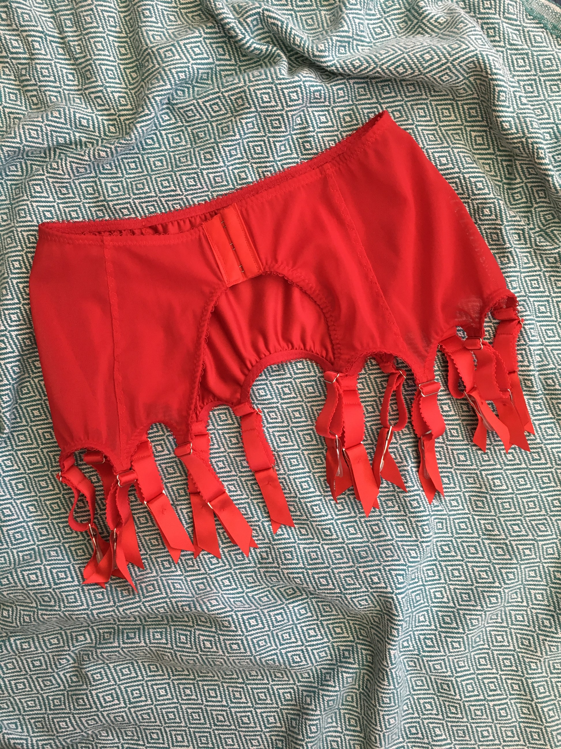 red satin shapewear lingerie. Vintage inspired valentines underwear. Red shapewear satin and red power net underwired bra, six strap suspender belt with steel garter clips and classic cut knicker or high waisted pantie girdle. Custom made red lingerie made to order in the UK. Red satin underwear with no lace. Perfect for Christmas and Valentines